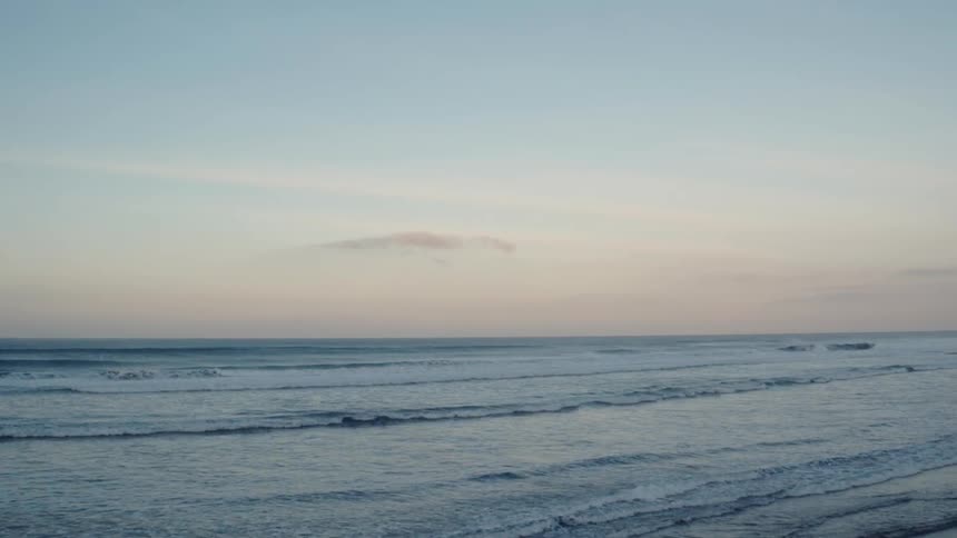 The waves flow onto the beach
