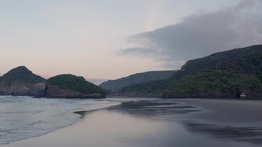 Waves flow onto the beach shore