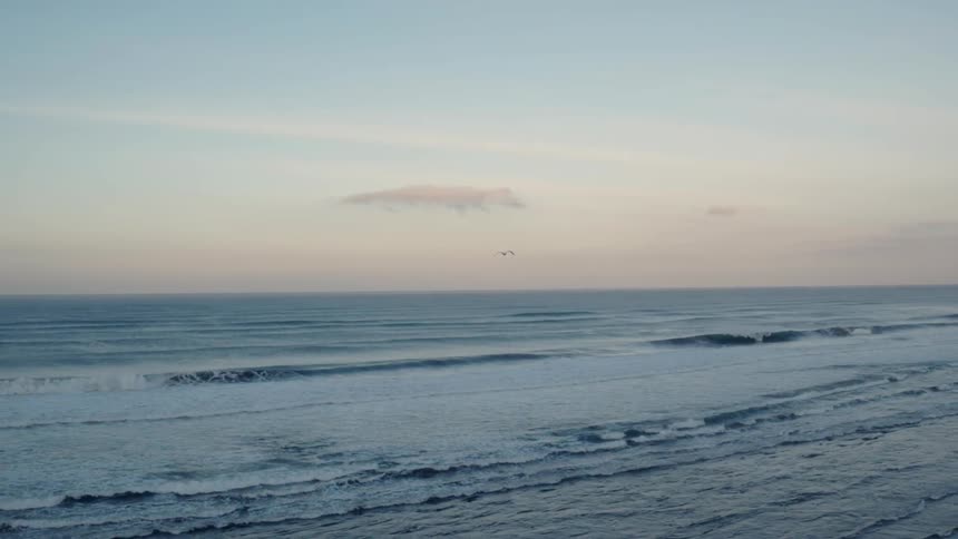 Waves flow onto the beach shore