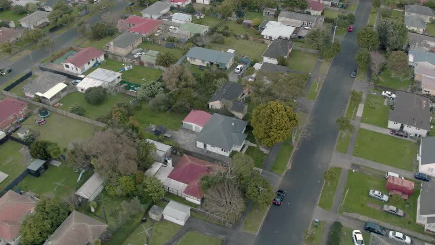 Residential houses and vehicles cover the landscape
