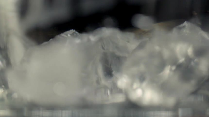 Ice cubes land on the bottom of a glass