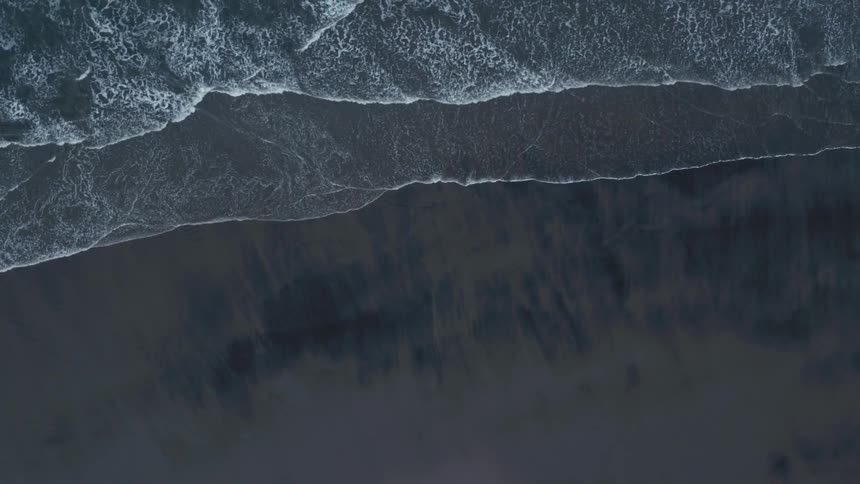 Waves flow onto the beach shore