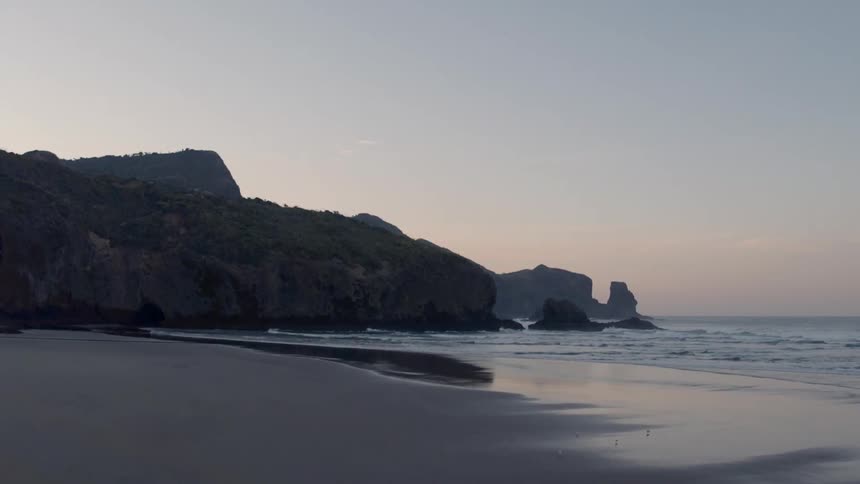 Waves flow onto the beach shore