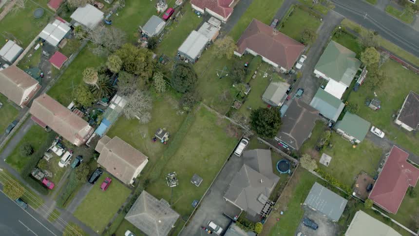 Residential houses and vehicles cover the landscape