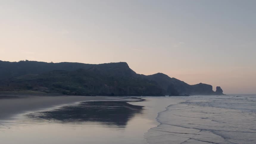 Waves flow onto the beach shore