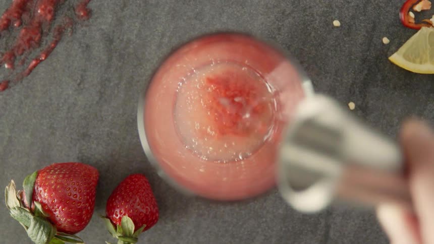 A man mixes a fruit drink