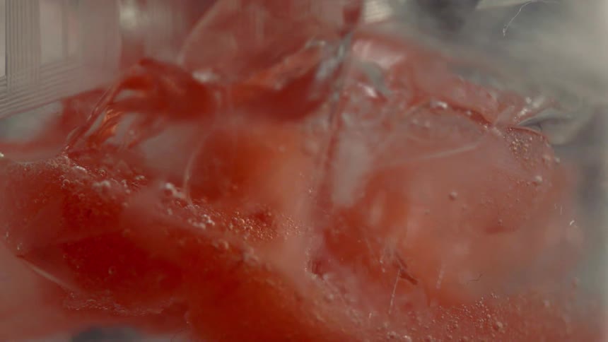 Pink liquid fills a cup