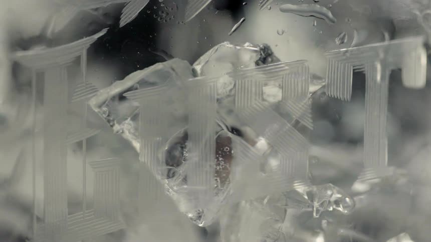 Ice falling into a glass