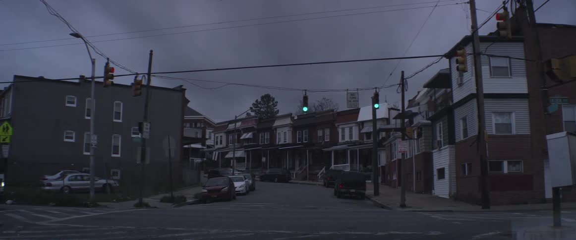 Drive through small town going through a yellow light