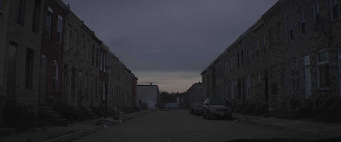 Cars are parked on a quiet town road