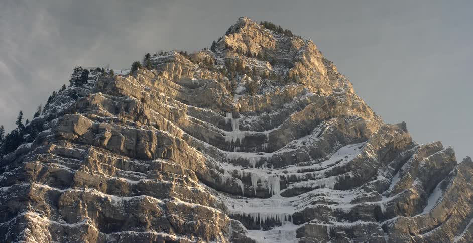 The tall mountain is covered with ice and snow