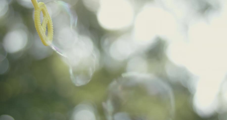 Someone blows bubbles outside