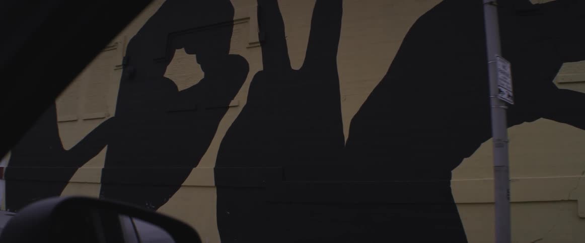 View of a graffiti sign through a car window