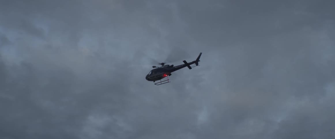 Helicopter flying through a cloudy sky
