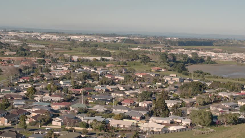 Looking over a hill down into a sprawling town