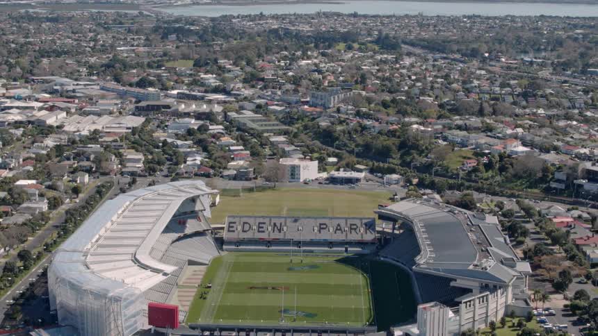 A football stadium sits empty in a coastal community during the day