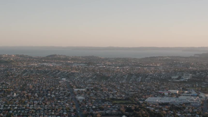 A city is shown at sunset