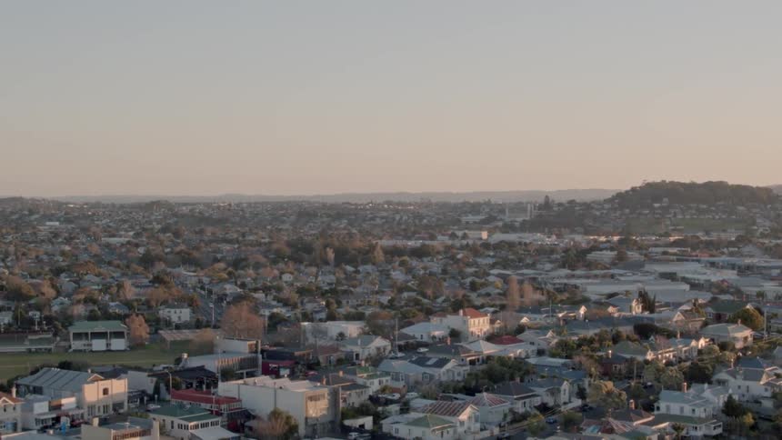 The sun is setting behind this town