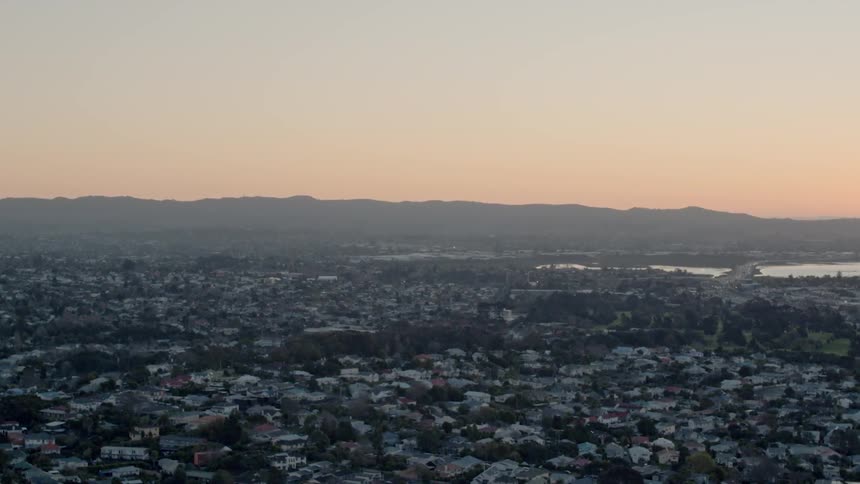 The sun sets over a city