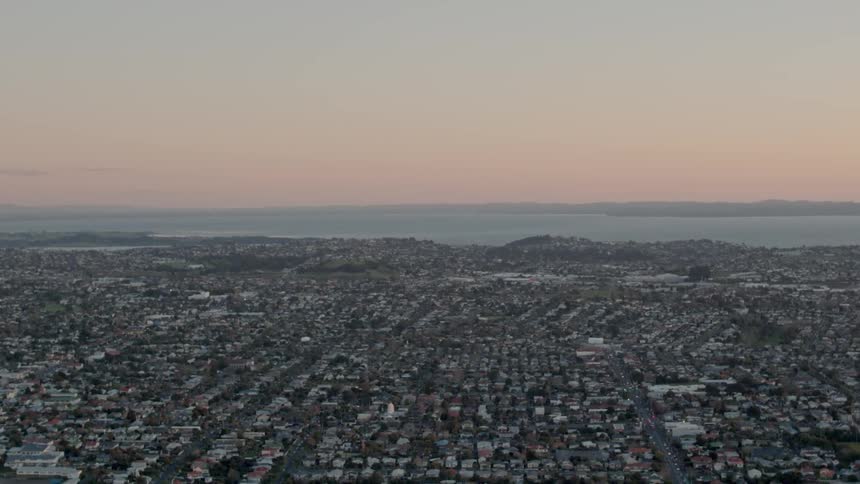 The sun sets over a city