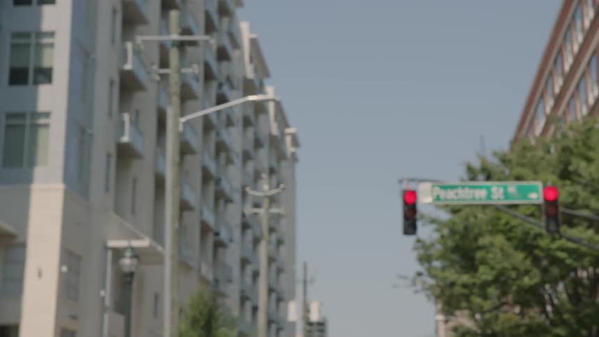 Stoplight and a building are blurry and come into view
