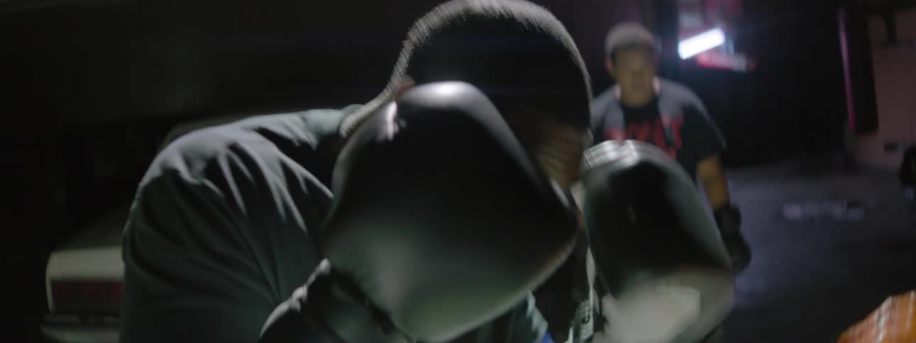 Man wearing boxing gloves practices hitting