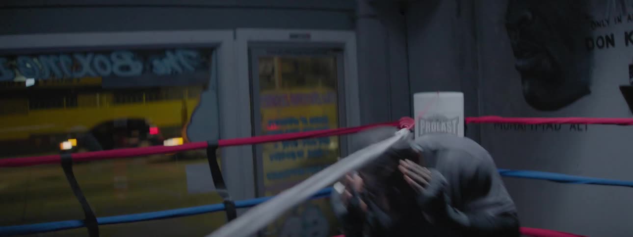 Man repeatedly ducks under a rope practicing boxing moves