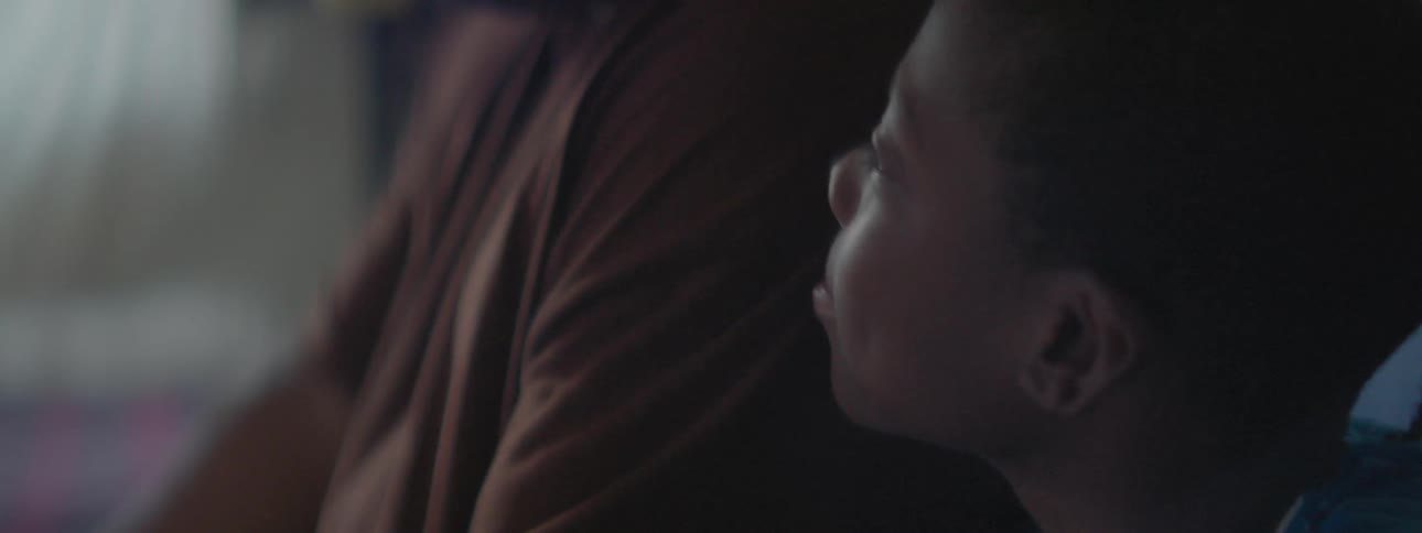 Man and boy sit next to each other in living room
