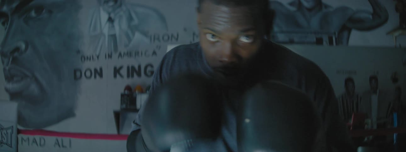 Man punches while wearing boxing gloves