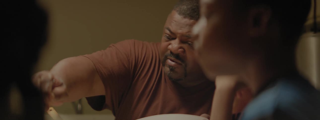 Family eats dinner at a table