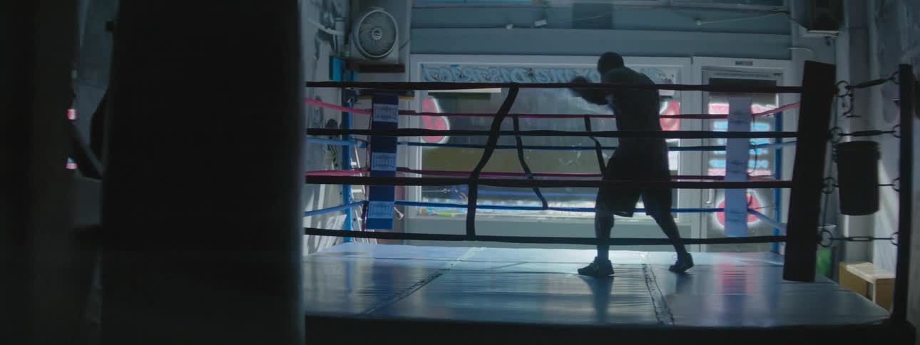 A man is shadowboxing in a ring