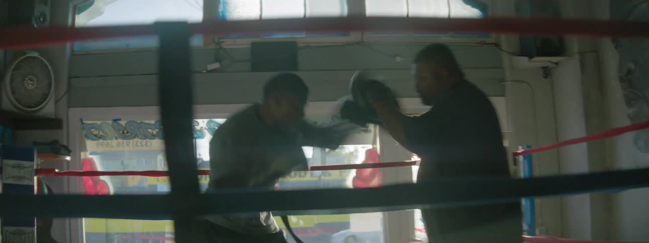 Two men box in boxing ring