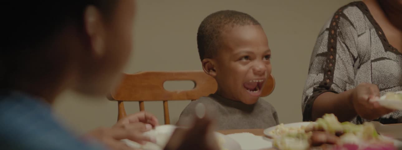 Family eats dinner at a table