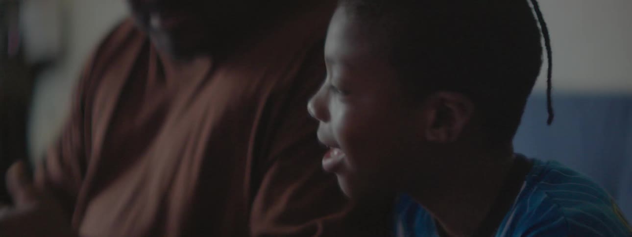A child sits near his father listening to him talk