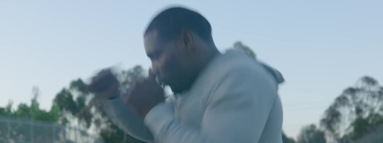 Man practicing punching while running outside