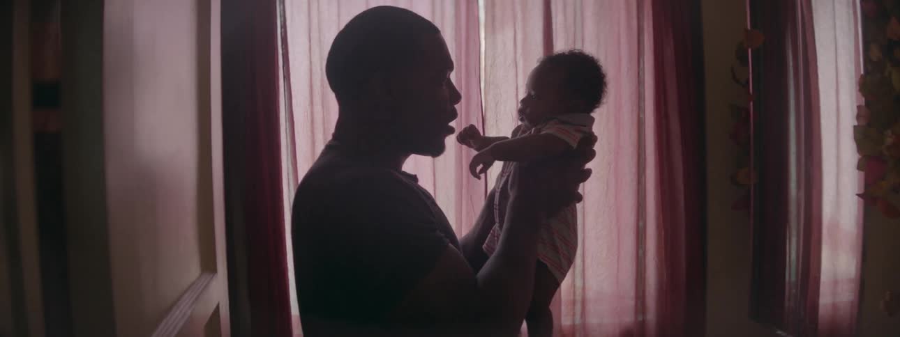 A man holds a little baby