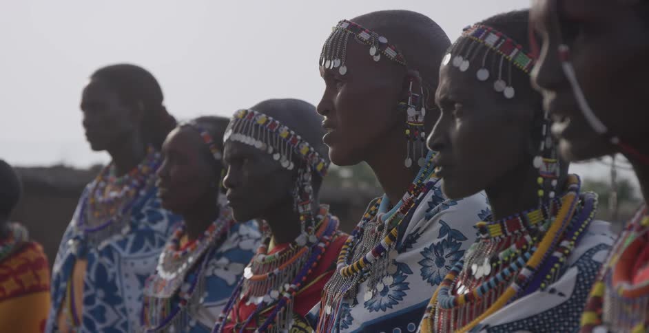 Group of maasai wearing costumes stand outside