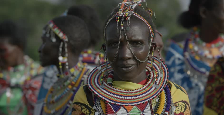 Maasai people talk and walk around