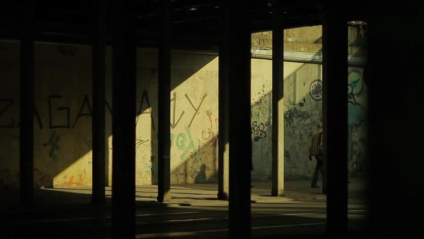 People are walking under a bridge