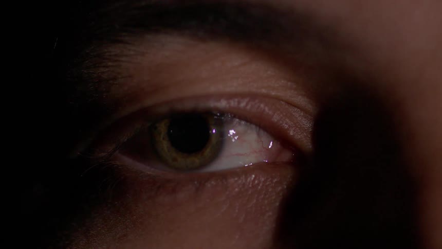 A person stares then closes their eye