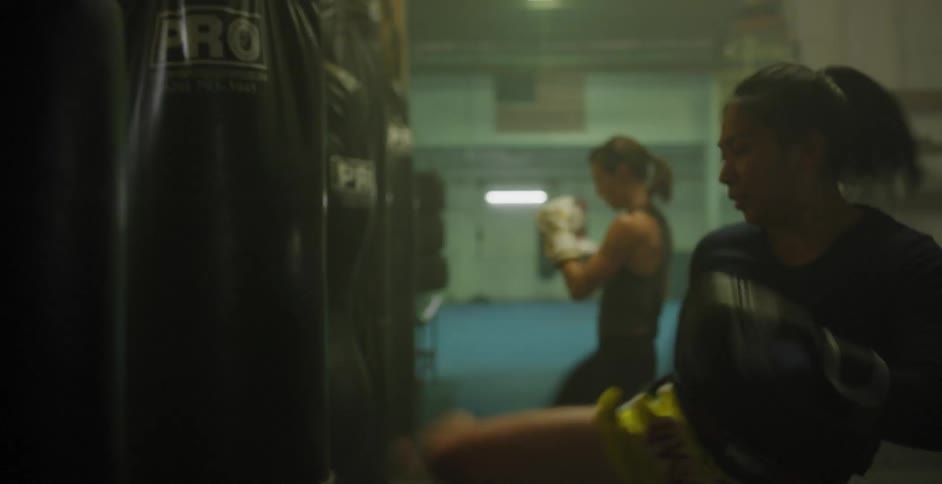 Women boxing  against punching bags