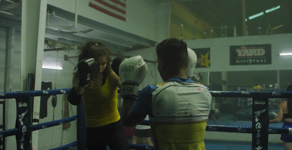 Two people box in a ring