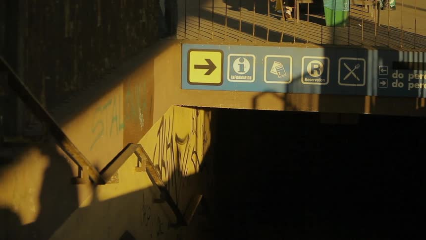 A shadow walks across the signs