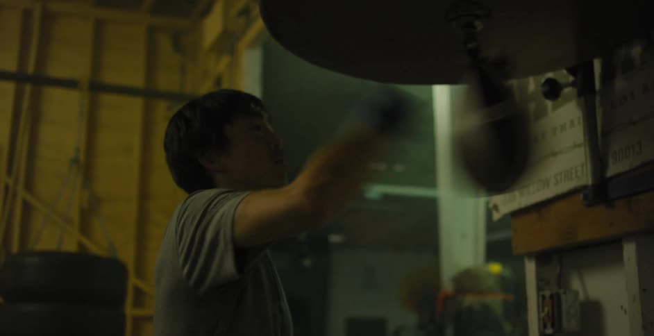 A man is punching a speed bag