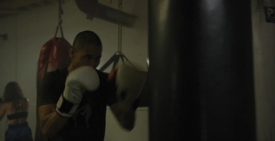 Man hits and kicks a punching bag