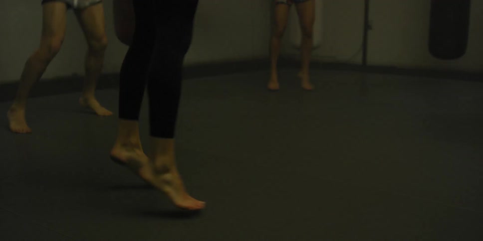 Women are doing jumping jacks in a gym