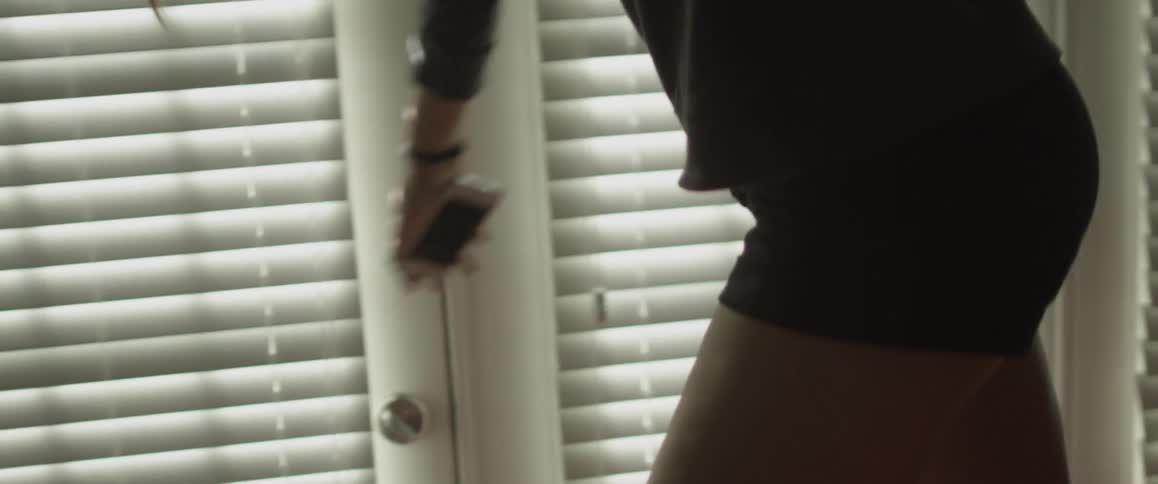 Person walking on top of furniture next to a window