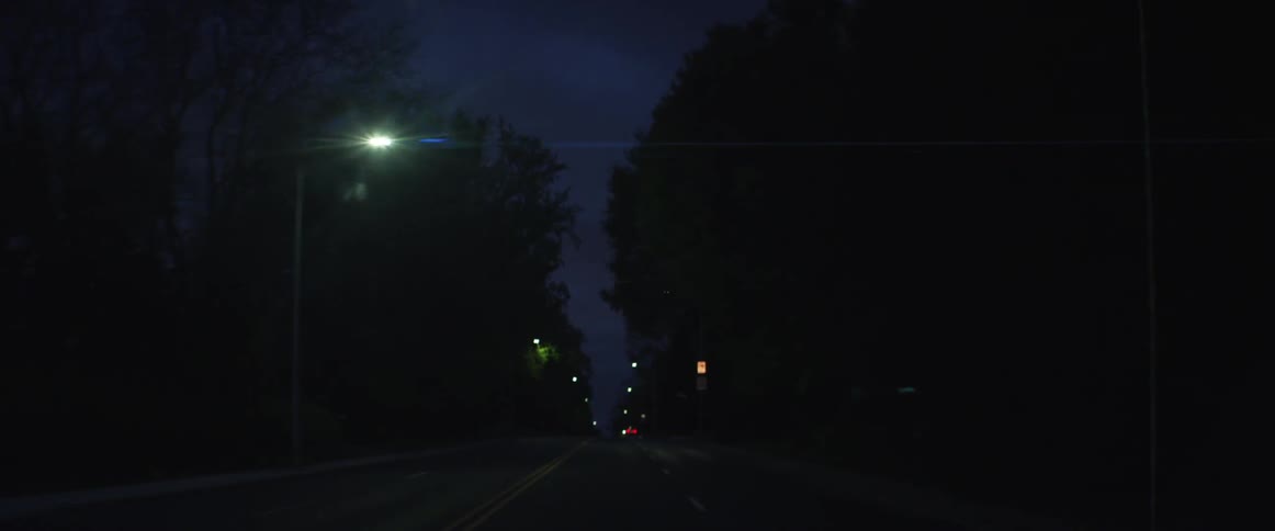 Driving down a street at night