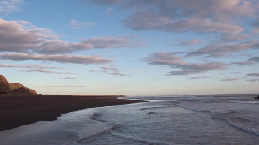 Waves flow onto the beach shore