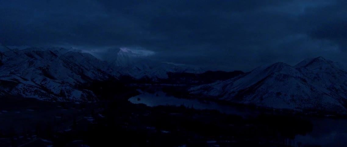 View of snowy mountains on a cloudy night
